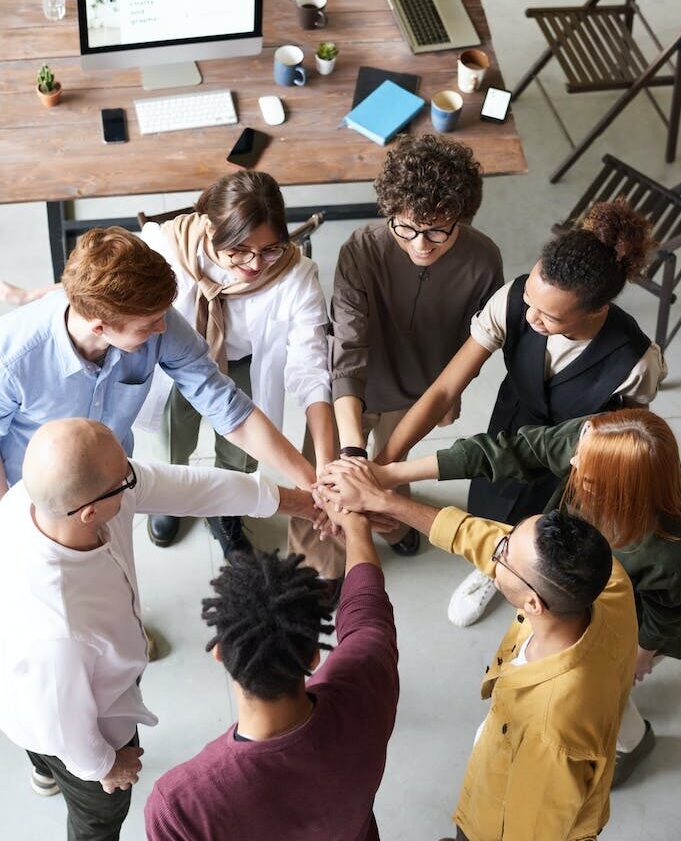 Photo Of People Holding Each Other's Hands